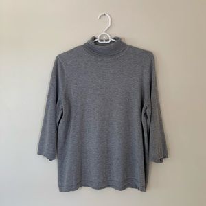 Chino’s gray turtleneck sweater
